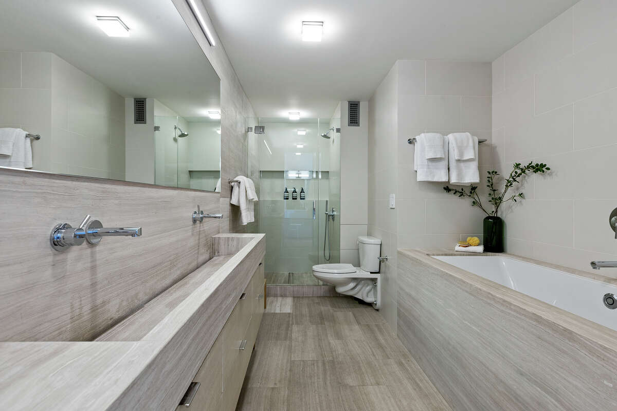 Updated, very luxurious bathrooms include this spa-like, marble-covered affair, with deep soaking tub.
