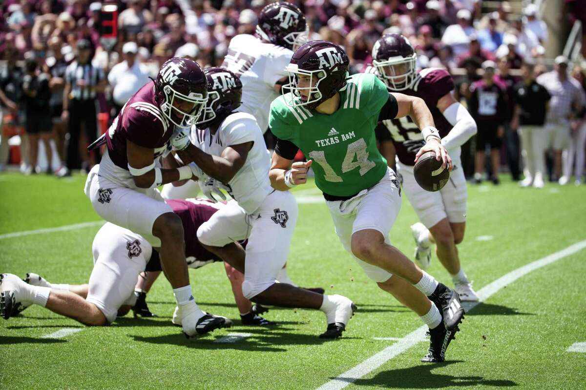 Texas A&M quarterback Max Johnson (14) runs around the end during the first half of the annual Maroon and White football game at Kyle Field Saturday, April 9, 2022, in College Station.