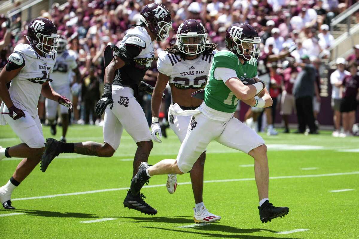 Texas A&M quarterback Haynes King (13) sprints into the end zone for a touchdown on a quarterback keeper during the first half of the annual Maroon and White football game at Kyle Field Saturday, April 9, 2022, in College Station.