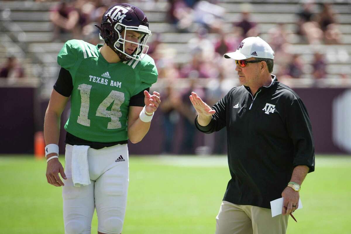 Texas A&M head coach Jimbo Fisher, right, talks to quarterback Max Johnson during the first half of the annual Maroon and White football game at Kyle Field Saturday, April 9, 2022, in College Station.