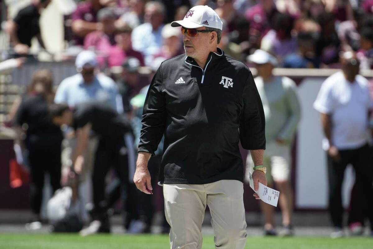 Texas A&M head coach Jimbo Fisher walks along the field behind the offense during the first half of the annual Maroon and White football game at Kyle Field Saturday, April 9, 2022, in College Station.