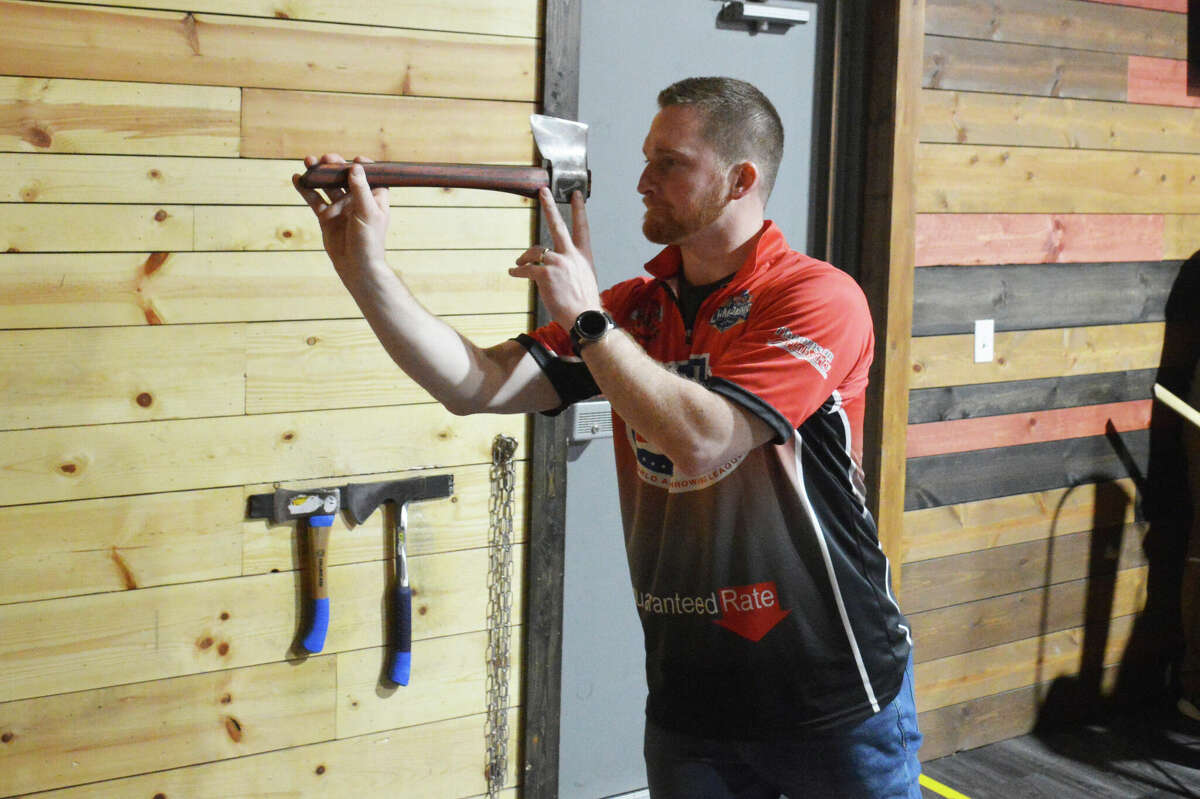Riverbend Axe Throwing owner Dan Brynildsen lines up his throw at the Riverbend Open on Saturday. 