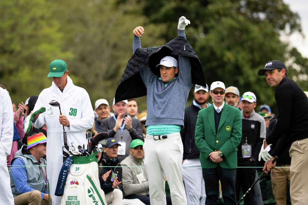 Scottie Scheffler dons a vest before beginning his round Saturday during third-round action at the Masters Tournament, in Augusta, Ga. The temperature never got above 50 degrees.
