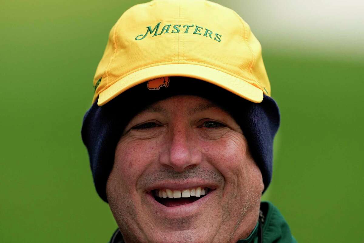 Gallery guard Steve Garner wears a wool cap underneath his Masters' cap to ward from the cold on the fourth hole during the third round at the Masters golf tournament on Saturday, April 9, 2022, in Augusta, Ga. (AP Photo/Robert F. Bukaty)