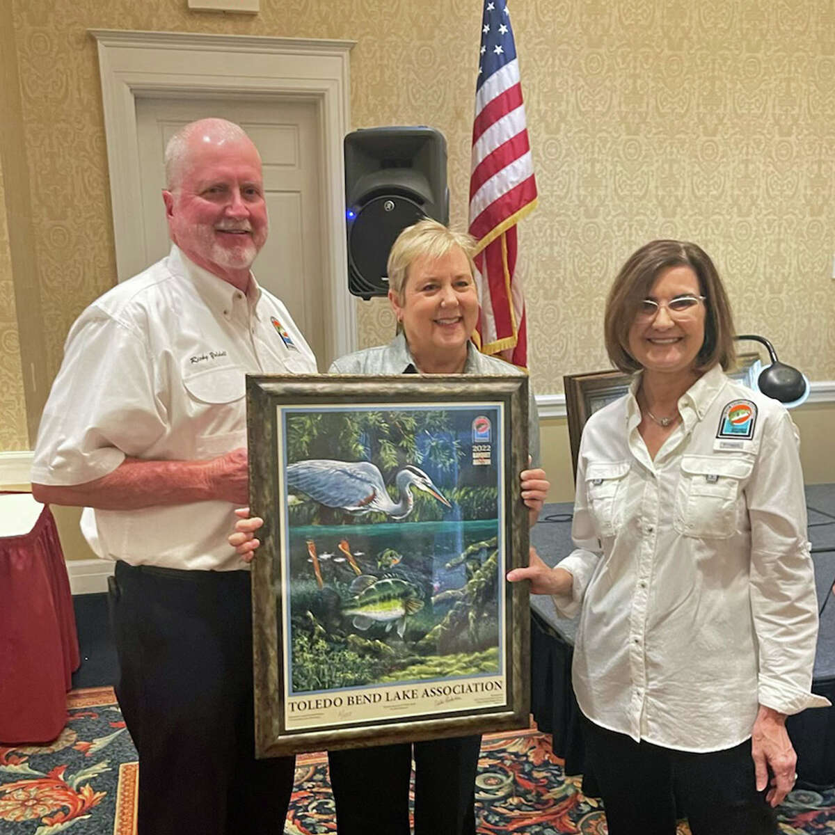 Dayna Yeldell, Owner/Broker of First Choice Real Estate Services and this year’s poster sponsor, is presented with the number two poster by Carolyn Scheurich, poster unveiling chairman. Pictured from left is Ricky and Dayna Yeldell, Carolyn Scheurich.