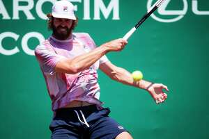 Reilly Opelka claims first clay title with win over John Isner