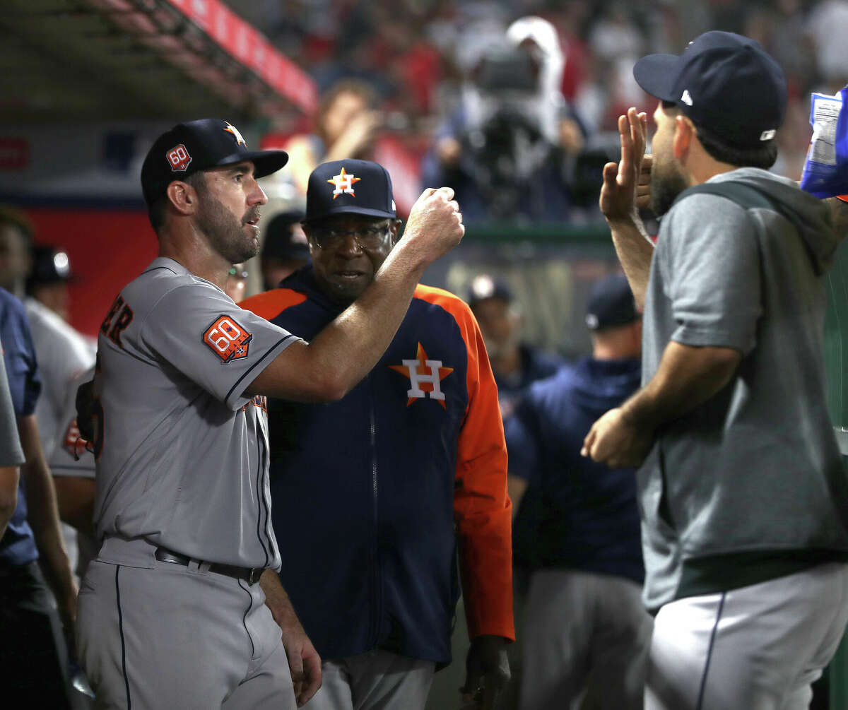 Houston Astros starting pitcher Justin Verlander (35) high-fives teammates and manager Dusty Baker Jr.in the dugout after the fifth inning of an MLB baseball game at Angel Stadium on Saturday, April 9, 2022 in Anaheim.