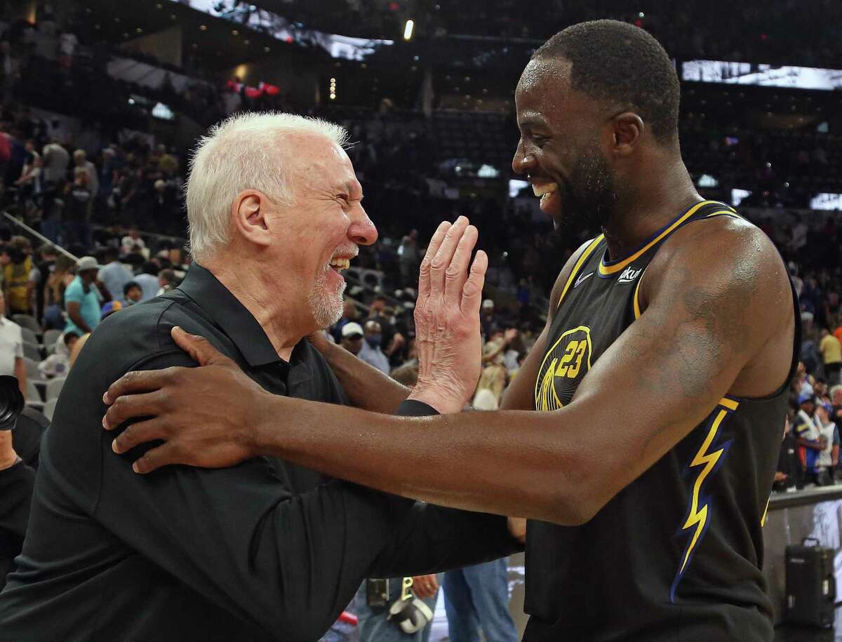Draymond Green of the Golden State Warriors greets Spurs head coach Gregg Popovich at the end of the game at AT&T Center on April 9, 2022 in San Antonio.