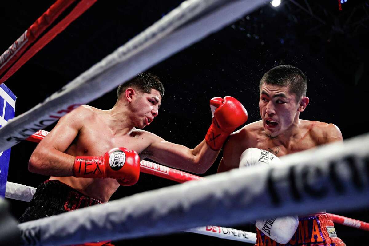 Katsuma Akitsugi exchanges punches with Gregory Morales during their featherweight bout at the Alamodome on April 9, 2022 in San Antonio.