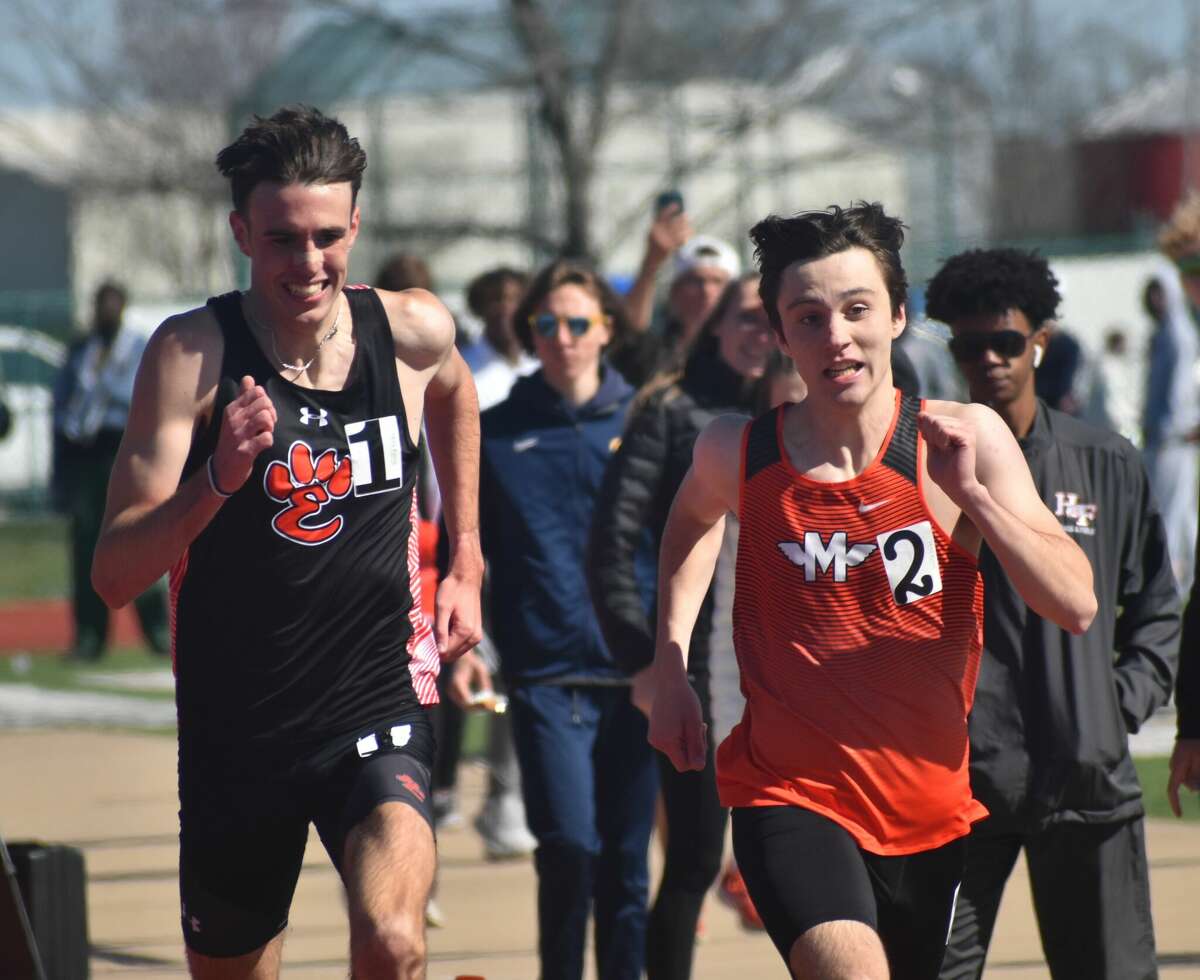 Edwardsville's Ryan Watts, left, chases down Minooka's Zachary Balzker in the 1,600-meter run during the Norm Armstrong Invitational at Belleville West on Saturday in Belleville.