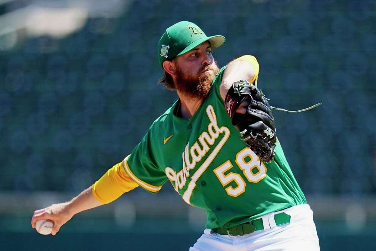 Oakland Athletics starting pitcher Paul Blackburn throws against the Colorado Rockies during the first inning of a spring training baseball game Saturday, April 2, 2022, in Mesa, Ariz. (AP Photo/Ross D. Franklin)