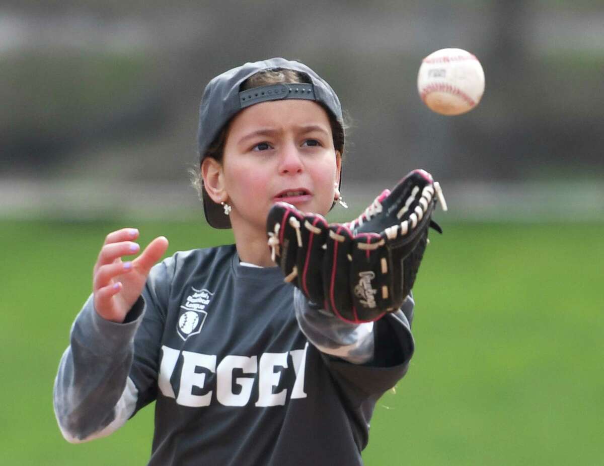 Sofia Rosenfeld catches the baseball during a game on opening day of the Fairfield County Connecticut Jewish Baseball League at Scalzi Park in Stamford, Conn. Sunday, April 10, 2022. The Jewish baseball league for children age pre-K through grade six began its season on Sunday.
