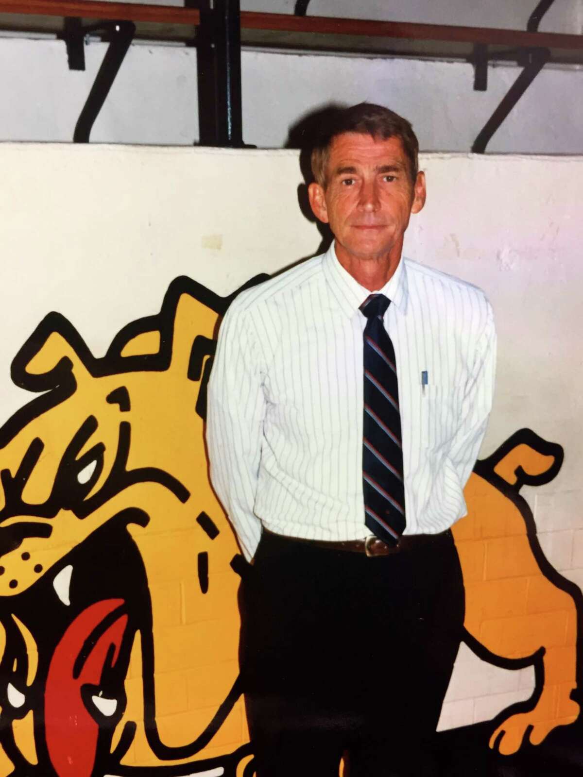 Texas Lutheran men’s basketball coach Jim Shuler poses for a photo at Memorial Gym in Seguin in 1998.