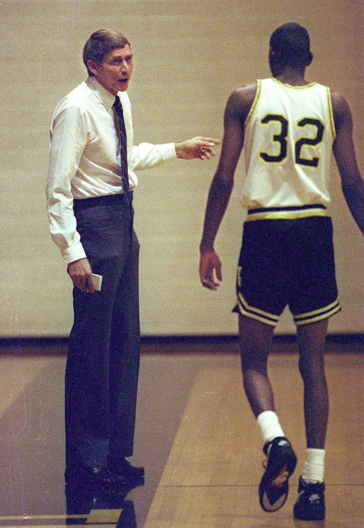 Texas Lutheran basketball coach Jim Shuler advises one of the team members in a 1992 match.