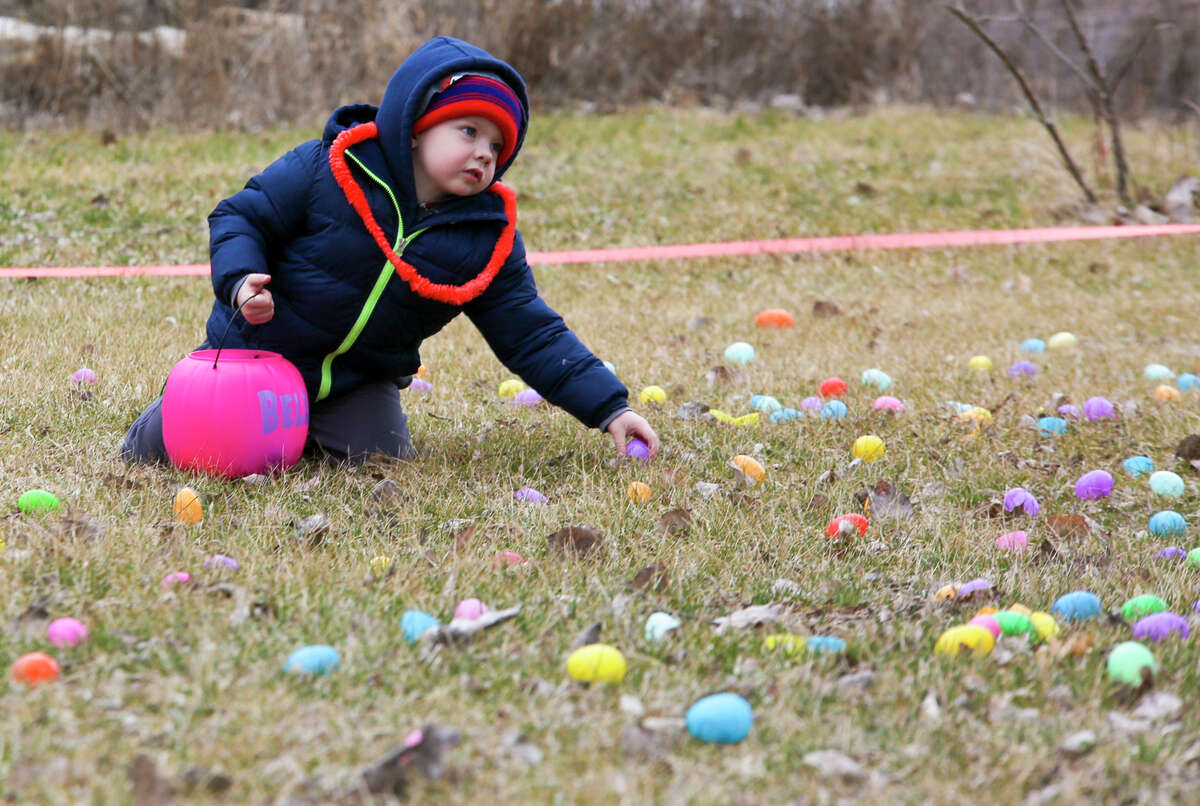 Dillon Endline picks up an egg during an Easter egg hunt on Saturday, April 9, 2022 in Porte Park in Sanford.