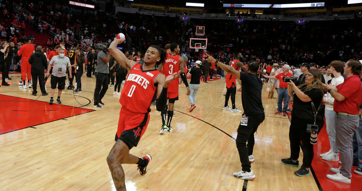 Houston Rockets guard Jalen Green (0) throws mini balls into the crowd of fans after the second half of an NBA basketball game at Toyota Center on Sunday, April 10, 2022, in Houston.