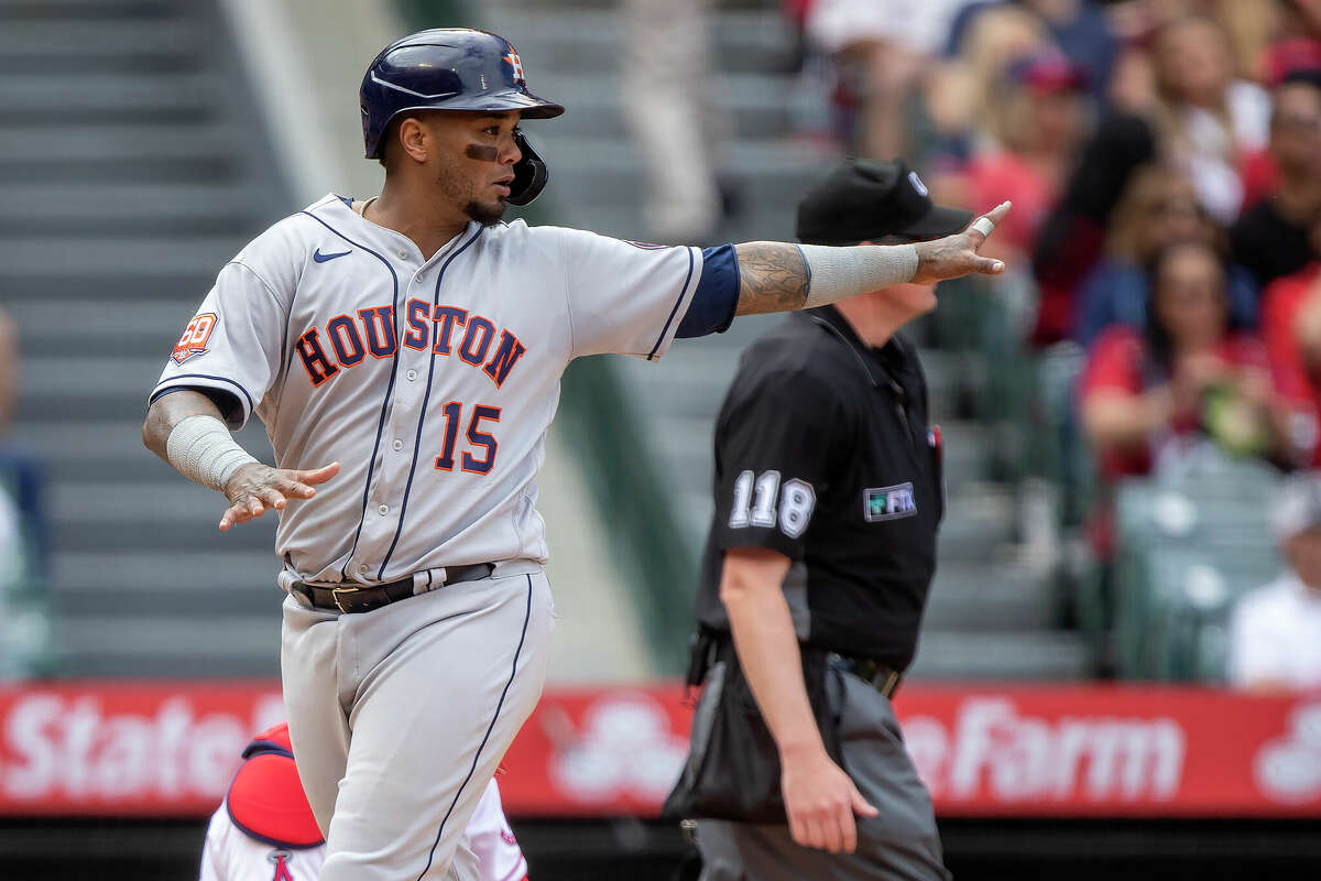 Houston Astros' Martin Maldonado points back to Jose Siri as they score on a single by Alex Bregman during the fifth inning of a baseball game against the Los Angeles Angels in Anaheim, Calif., Sunday, April 10, 2022. (AP Photo/Alex Gallardo)