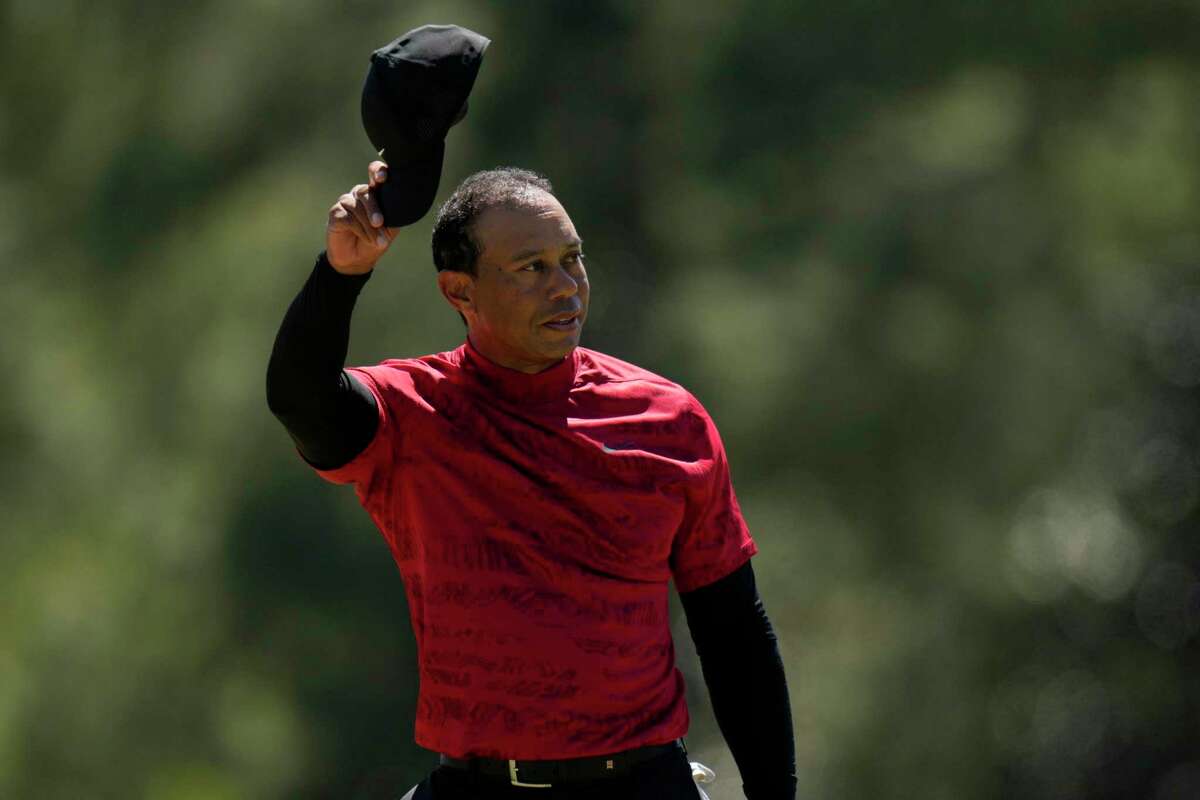 Tiger Woods tips his cap on the 18th green during the final round of the Masters tournament.