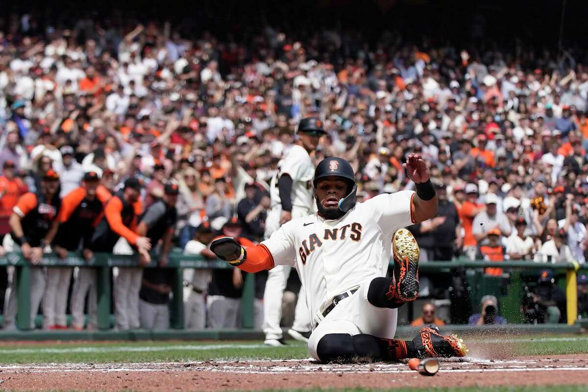 San Francisco Giants' Heliot Ramos slides home to score against the Miami Marlins during the second inning of a baseball game in San Francisco, Sunday, April 10, 2022. (AP Photo/Jeff Chiu)