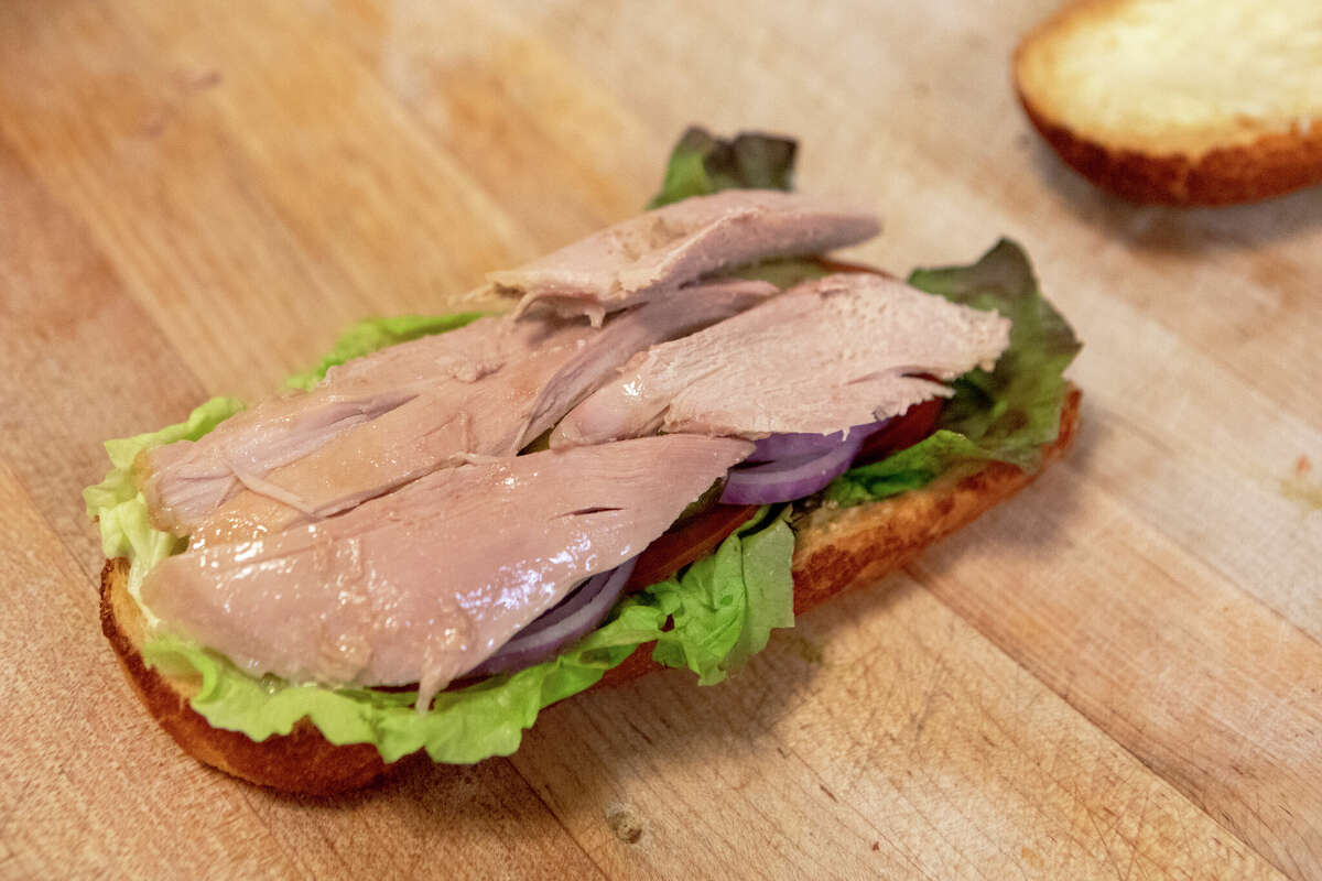 A hot roasted turkey sandwich being assembled at Arguello Market in San Francisco, Calif. on Apr. 10, 2022. The market is the self-described home of the 'World Famous Turkey Sandwich.'