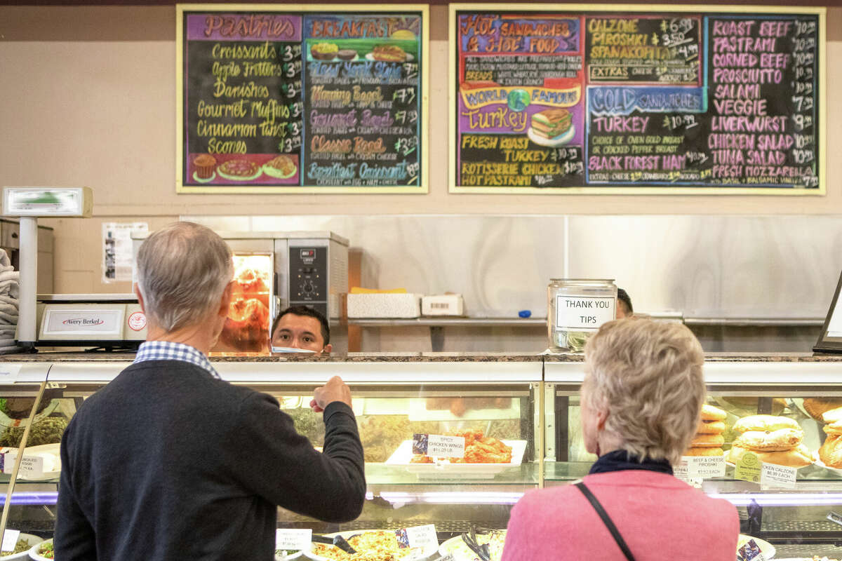 Deli customers order a hot roasted turkey sandwich at Arguello Market.
