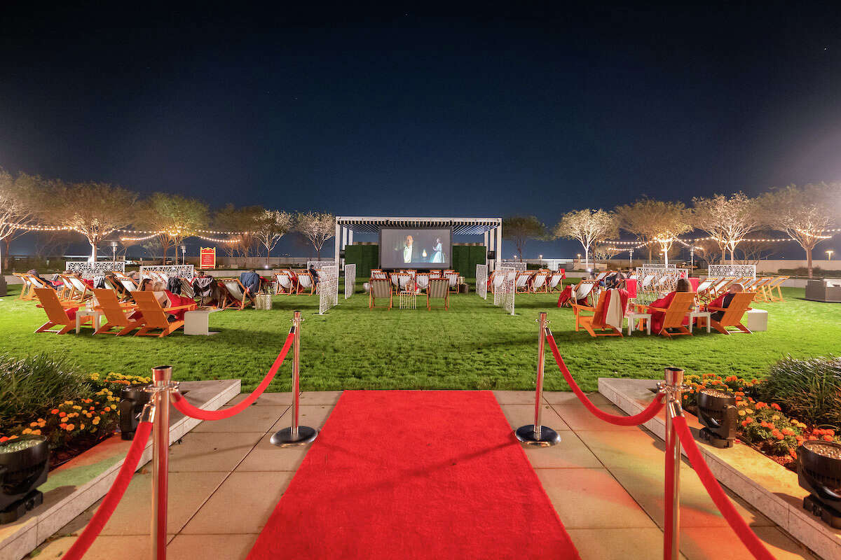 Howard Hughes has turned this office outdoor plaza at The Woodlands Towers at The Waterway into a place to host community gatherings and events such as movie nights (pictured) and volleyball games. The real estate developer hired Gensler to make further enhancements to its headquarters offices in The Woodlands post pandemic.