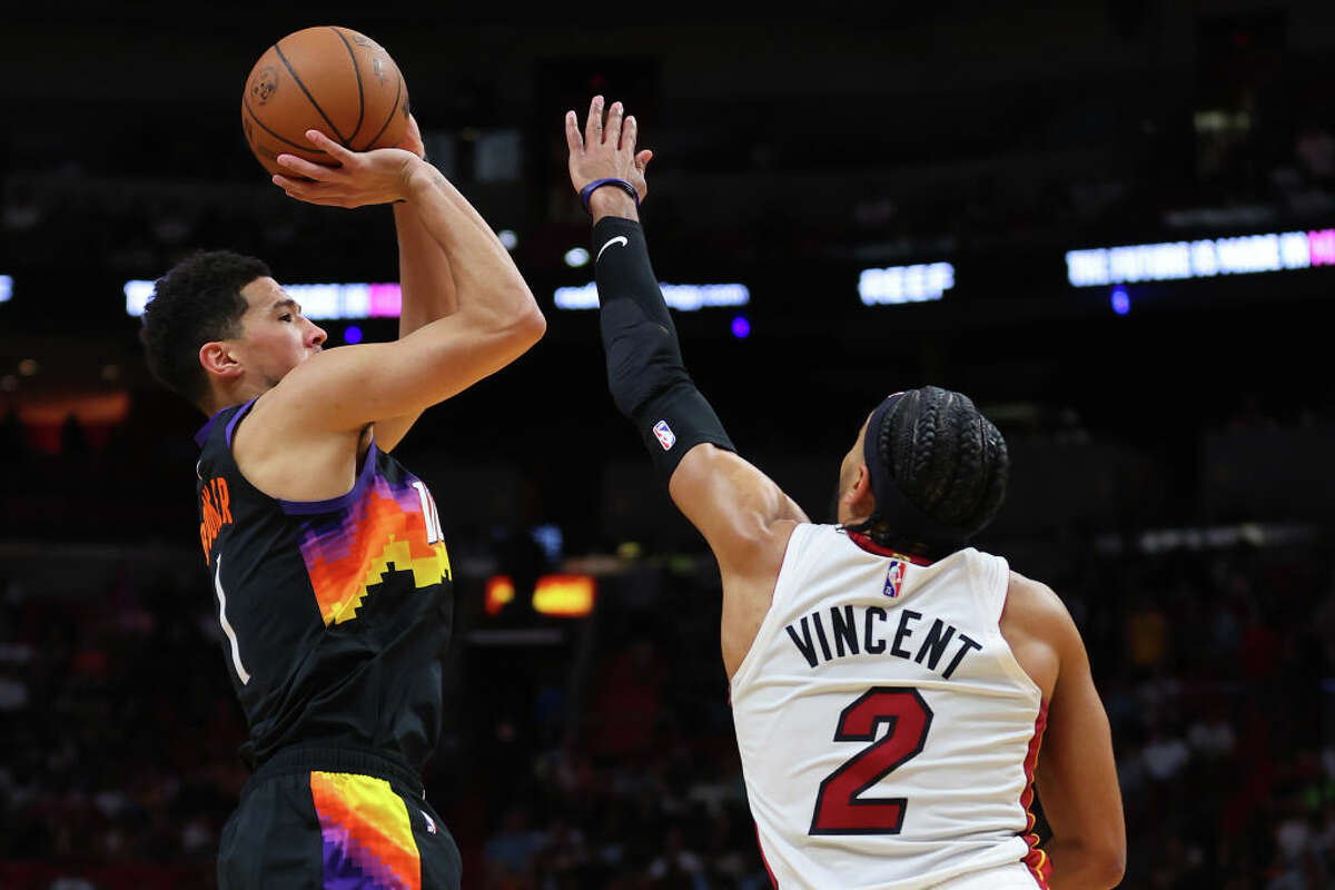 Devin Booker #1 of the Phoenix Suns shoots over Gabe Vincent #2 of the Miami Heat during the second half at FTX Arena on March 9, 2022 in Miami. (Photo by Michael Reaves/Getty Images)