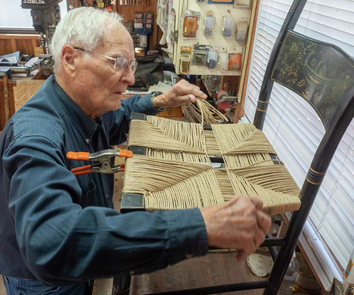 Don McSparran works on caning a chair seat 04/11/2020 in his workshop. Tim Fischer/Reporter-Telegram