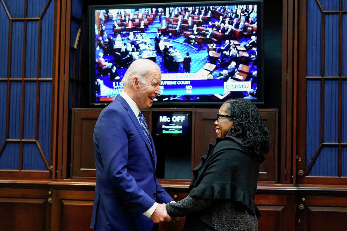 President Joe Biden holds hands with Supreme Court nominee Judge Ketanji Brown Jackson as they watch the Senate vote to approve her historic confirmation to the U.S. Supreme Court.