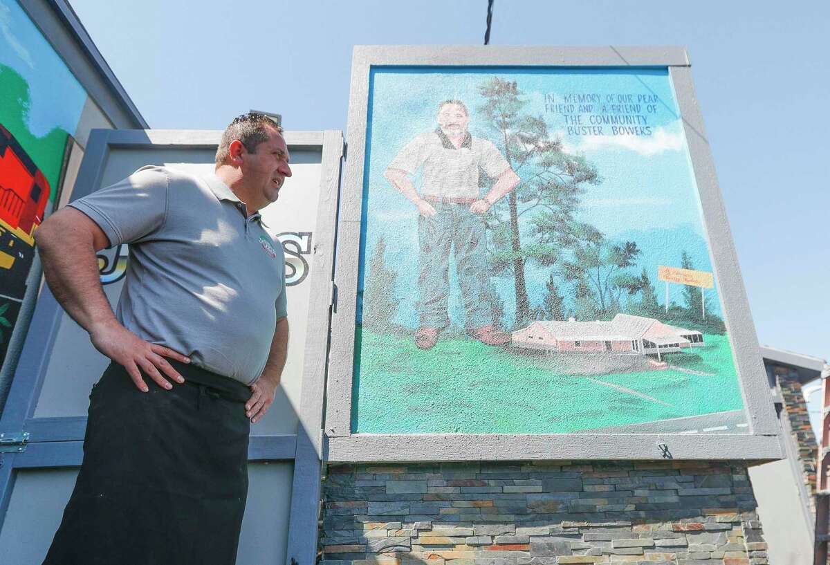 Joe Haliti, owner of Joe's Italian Restaurant, talks about his mentor and Vernon's Kuntry Katfish owner Buster Bowers, Friday, April 1, 2022, in Conroe. Haliti, who is adding Conroe icons to the murals around his restaurant, added one of Bowers, who suddenly at age 44 of a heart attack in September 2017.