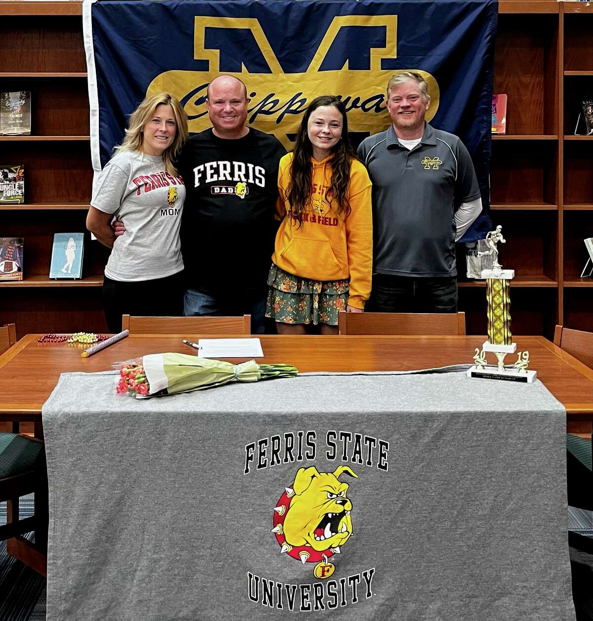 Allie Thomas celebrates her commitment to Ferris State University with her parents and coach. (Left to right: Melissa Thomas, Jason Thomas, Allie Thomas, and Eric Thuemmel)