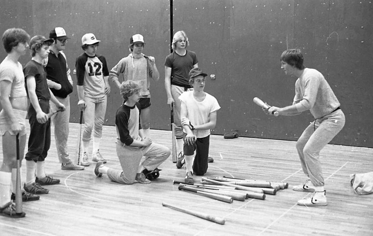 The Manistee High School diamond men are getting some bunting instruction from assistant coach Tom Tomaszewski  while the ground is wet and still partly snow-covered. (From left) Jason Stamp, Jim Raczykowski, Russell Cady, Todd Golnick, Troy Guzikowski and Jim Kuhr are shown. Kneeling in front are Tim Golnick and Rich Baker. The photo was published in the News Advocate on April 12, 1962.