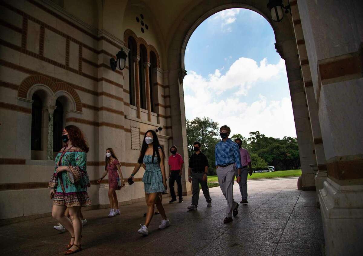 New Rice University students enter the university through the Sallport archway on Friday, Aug. 21, 2020, in Houston as part of the ceremonial event to welcome them.