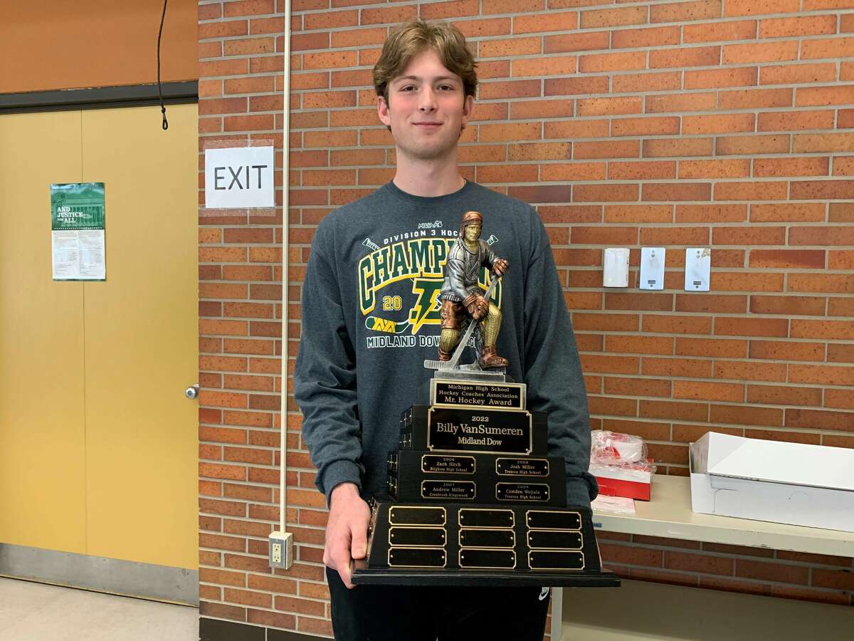Dow High's Billy VanSumeren poses with the Mr. Hockey trophy following a ceremony at the Dow cafeteria on Monday, April 11, 2022.
