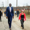 Lt. Governor Garlin Gilchrist II, left, chats with Sanford Village President Dolores Porte, right, as they walk towards Sanford Dam during Gilchrist's visit to survey the progress made on flood recovery efforts in downtown Sanford and at the Sanford Dam Monday, April 11, 2022.