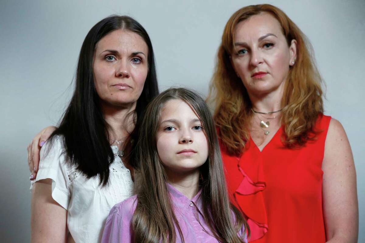 Kateryna Krezhenstouska (l-r) and daughter is Alisa,12 years old, fled their home in the Ukraine with the helps of their friend, Yana Kristal, pose for a photo Wednesday, April 6, 2022, in Houston.
