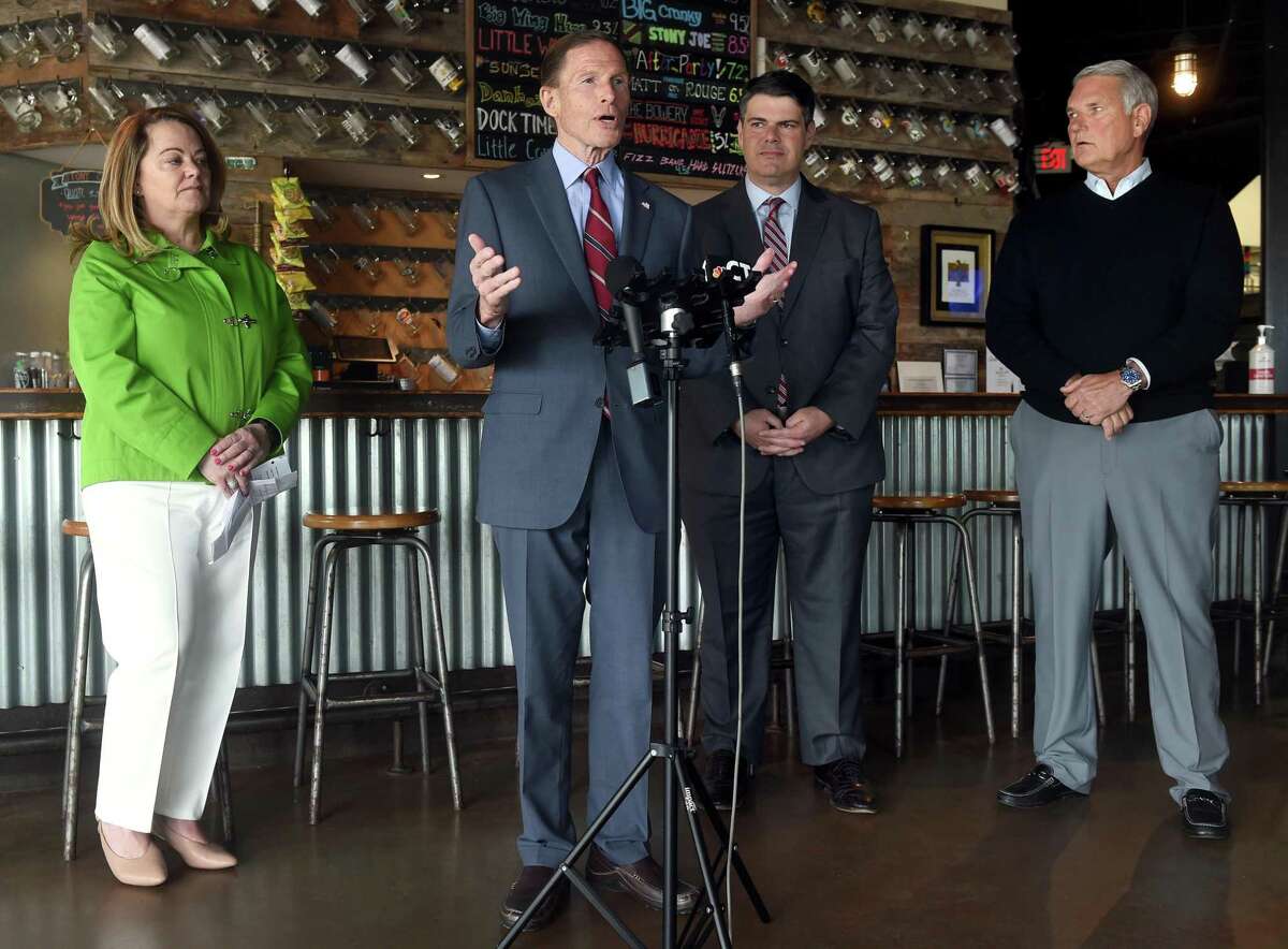 U.S. Senator Richard Blumenthal speaks at a press conference at the Stony Creek Brewery in Branford on April 11, 2022 to highlight pandemic aid awarded to small businesses during the COVID-19 pandemic. From left are Small Business Administration Connecticut District Director Catherine Marx, Blumenthal, U.S. SBA Regional Administrator Mike Vlacich and Stony Creek Brewery owner Ed Crowley.