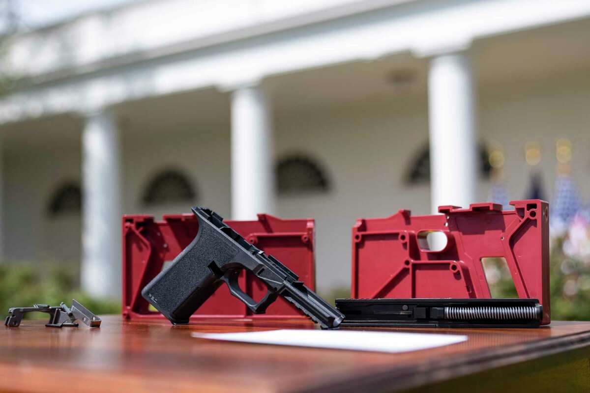 A ghost gun is displayed in the Rose Garden of the White House on Monday for President Biden’s announcement of a new firearm regulation aimed at reining the untraceable, unregulated weapons.