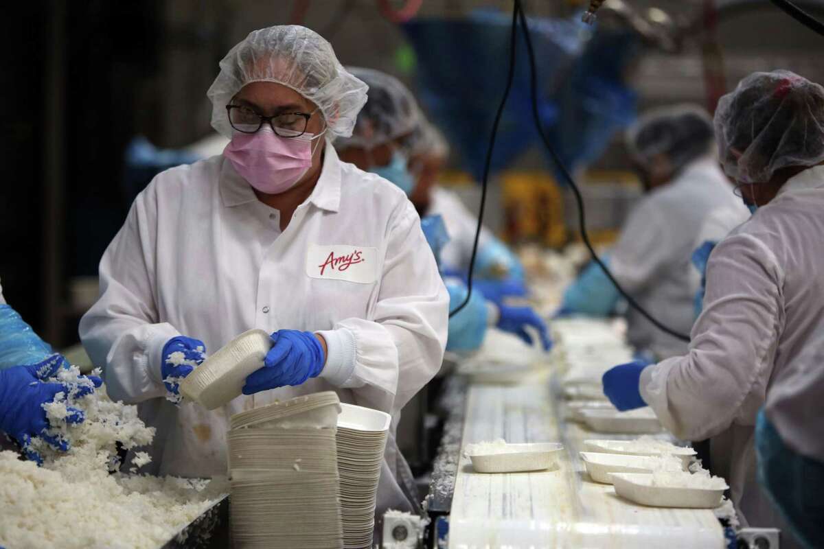 Factory workers gather ingredients to make ravioli dishes at Amy’s Kitchen in Santa Rosa.