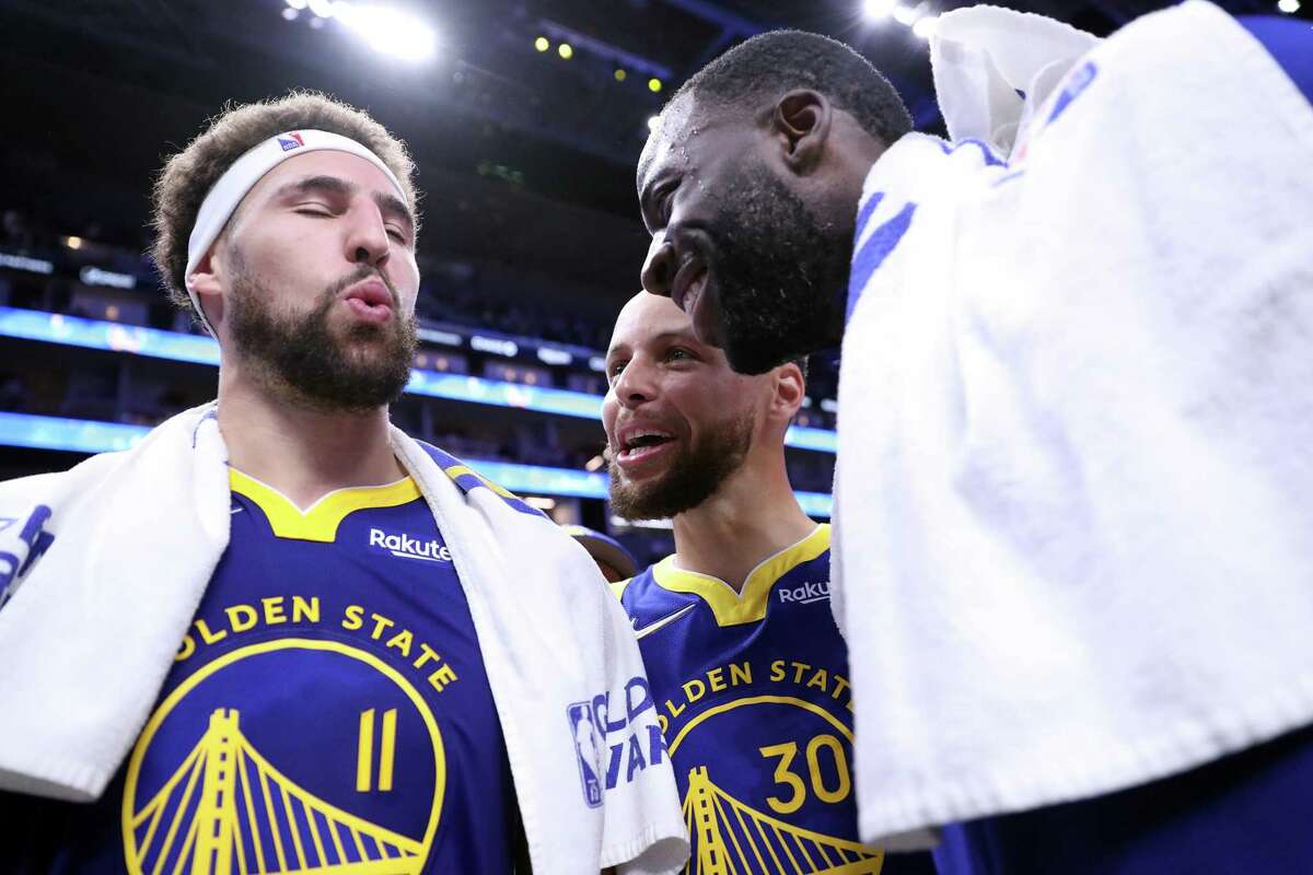 Golden State Warriors' Klay Thompson, Stephen Curry and Draymond Green relish in being reunited after Warriors' 126-112 win over Washington Wizards in NBA game at Chase Center in San Francisco, Calif., on Monday, March 14, 2022.