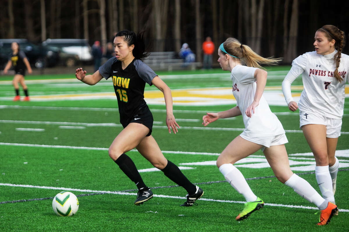Dow's Lucy Teed dribbles down the field during the Chargers' 1-0 victory over Flint Powers Catholic Monday, April 11, 2022 at H. H. Dow High School.
