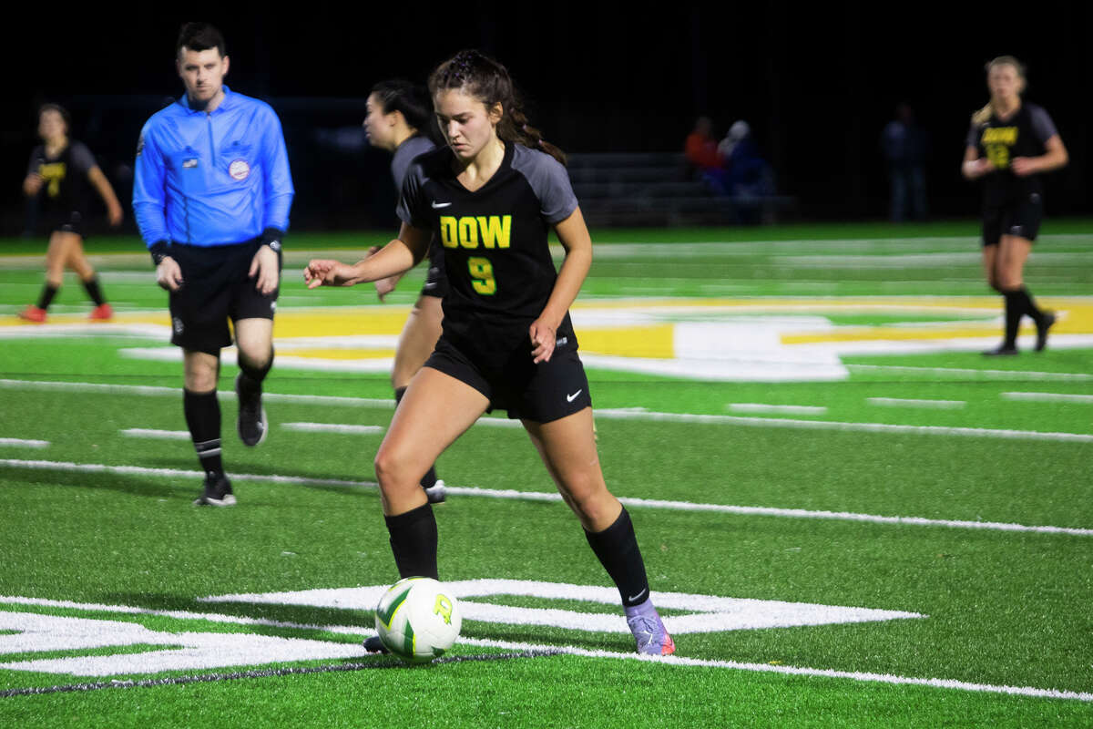 Dow's Alaina Schalk dribbles down the field during the Chargers' 1-0 victory over Flint Powers Catholic Monday, April 11, 2022 at H. H. Dow High School.