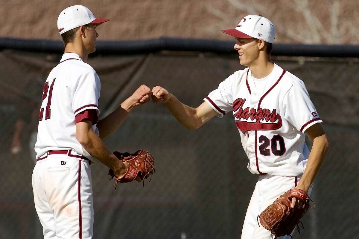 Tyler and Taylor Rogers bump fists after a high school game in Colorado.