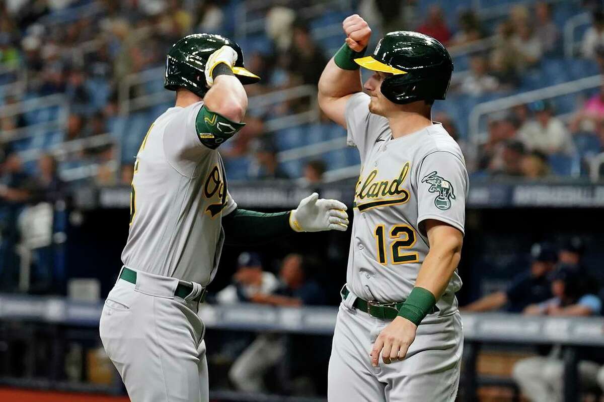 Oakland Athletics' Seth Brown celebrates with Sean Murphy (12) after Brown hit a three-run home run off Tampa Bay Rays relief pitcher Chris Mazza during the first inning of a baseball game Monday, April 11, 2022, in St. Petersburg, Fla. (AP Photo/Chris O'Meara)