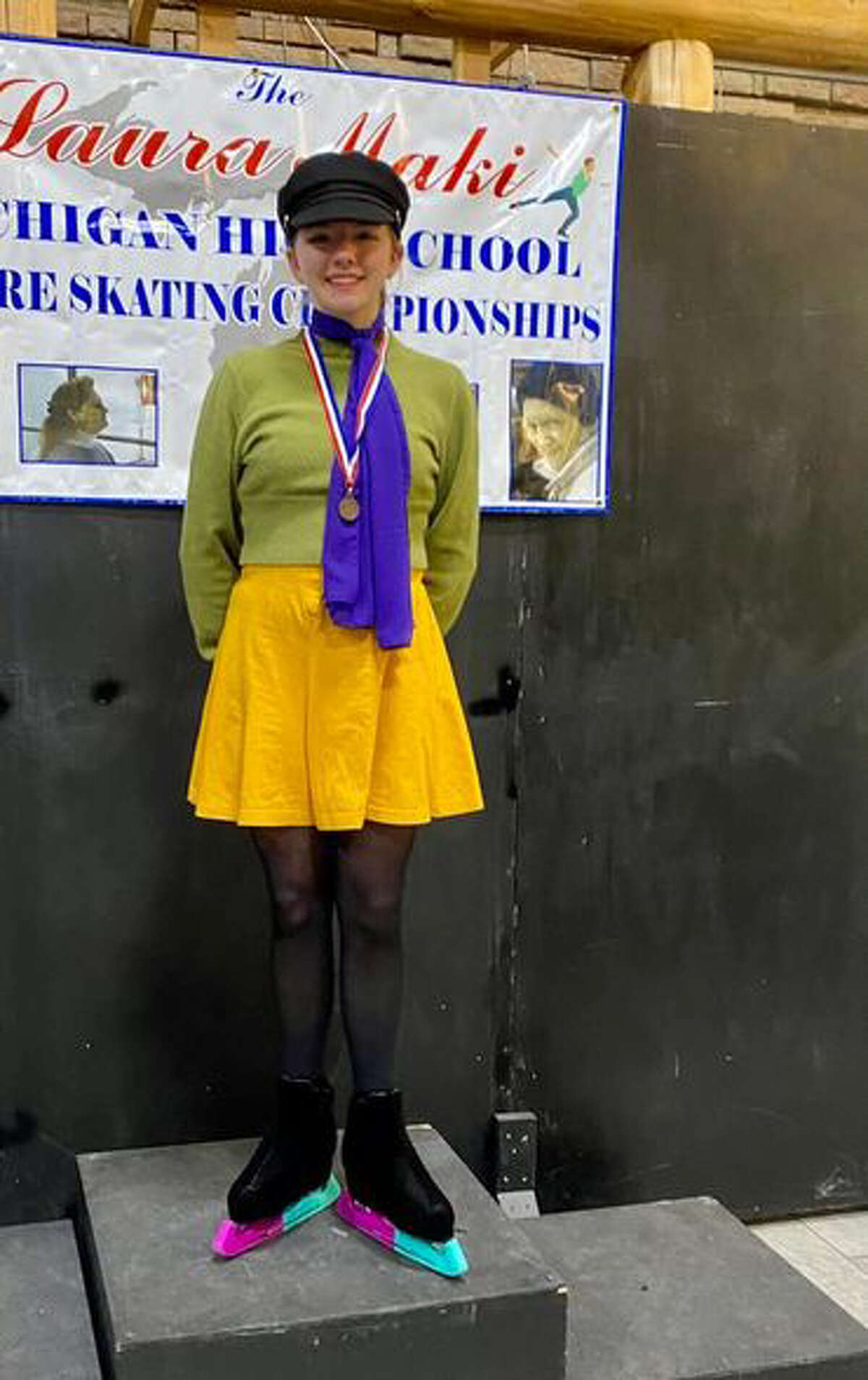 Midland Area's Ciarra Franklin poses with her state championship medal after winning the Pre-Silver Dance title in ice dancing at the high school state finals in Brighton recently.