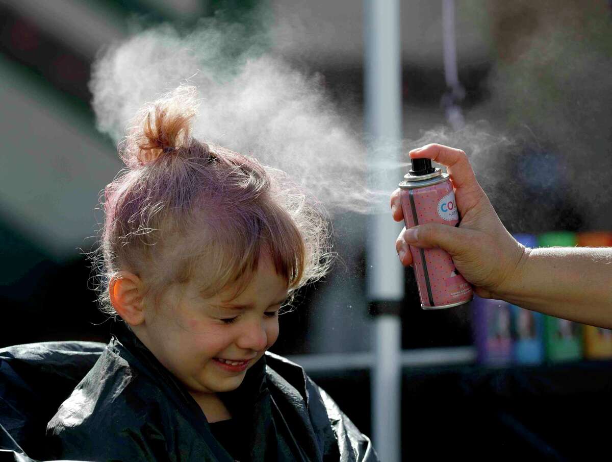 Kali Outrey has her hair colored during the annual Kidzfest, Saturday, April 24, 2021, in Conroe.