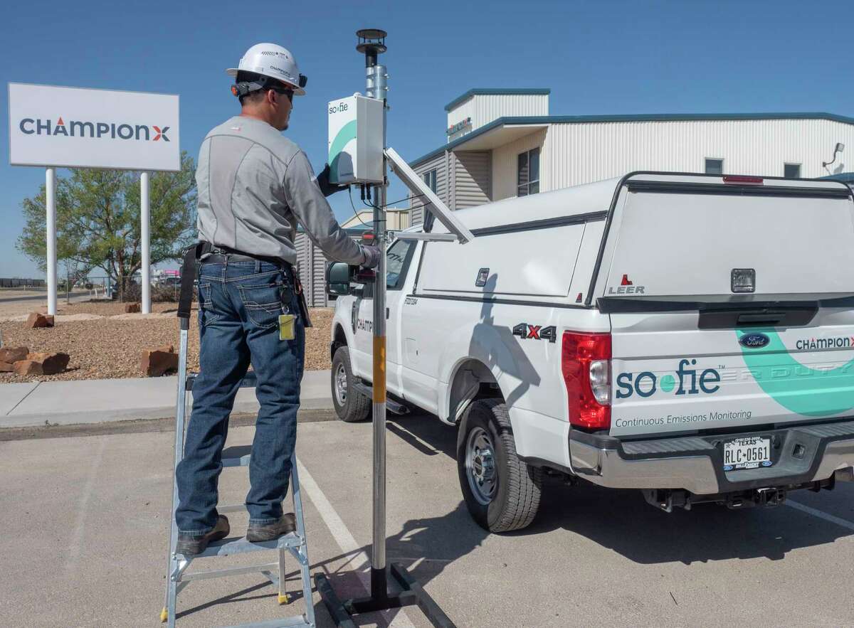 Gabe Gonzalez, emissions technician, sets up one of the Sofie System continues methane monitors 04/12/2020 outside ChampionX laboratory. Area producers have installed more than 1000 units in the Permian Basin already to help detect and track air samples around well sites. Tim Fischer/Reporter-Telegram