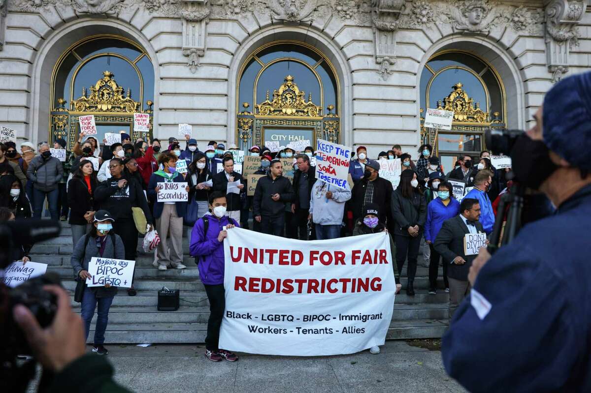 People rally against the proposed redistricting of neighborhoods on the steps of City Hall in San Francisco on Monday.