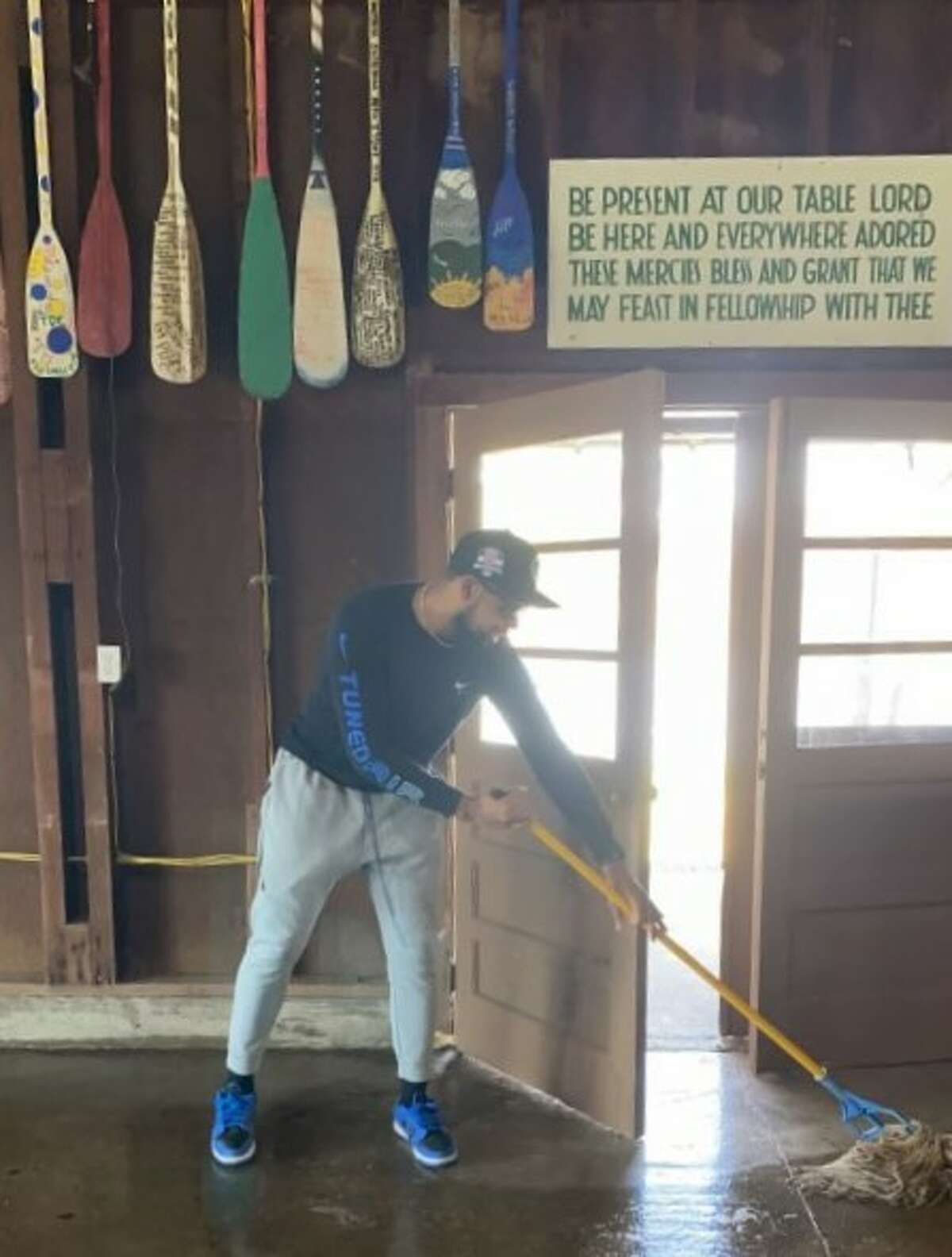 A member of the Illinois College football team help clean up the Western Illinois Youth Camp earlier this month. The team has helped at the camp for many years.