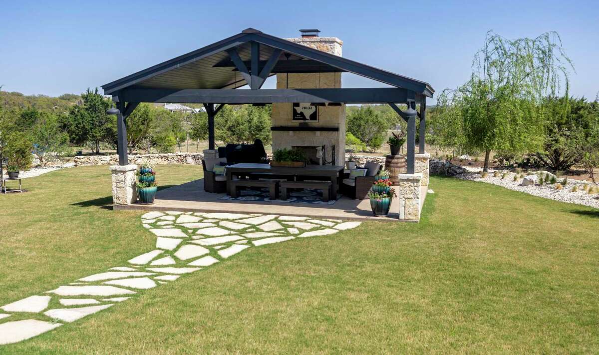 The centerpiece of the backyard is the covered pavilion measuring 18 feet by 24 feet. It has a peaked roof with Douglas fir beams, a tongue-and-groove ceiling and a fireplace with limestone veneer.